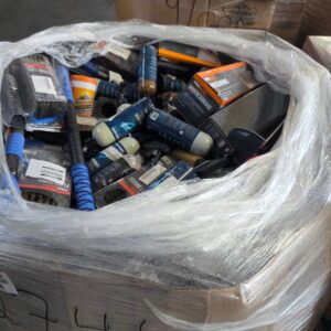 Automotive fluids liquidation pallet stacked with sealed motor oil, coolant and transmission fluid jugs