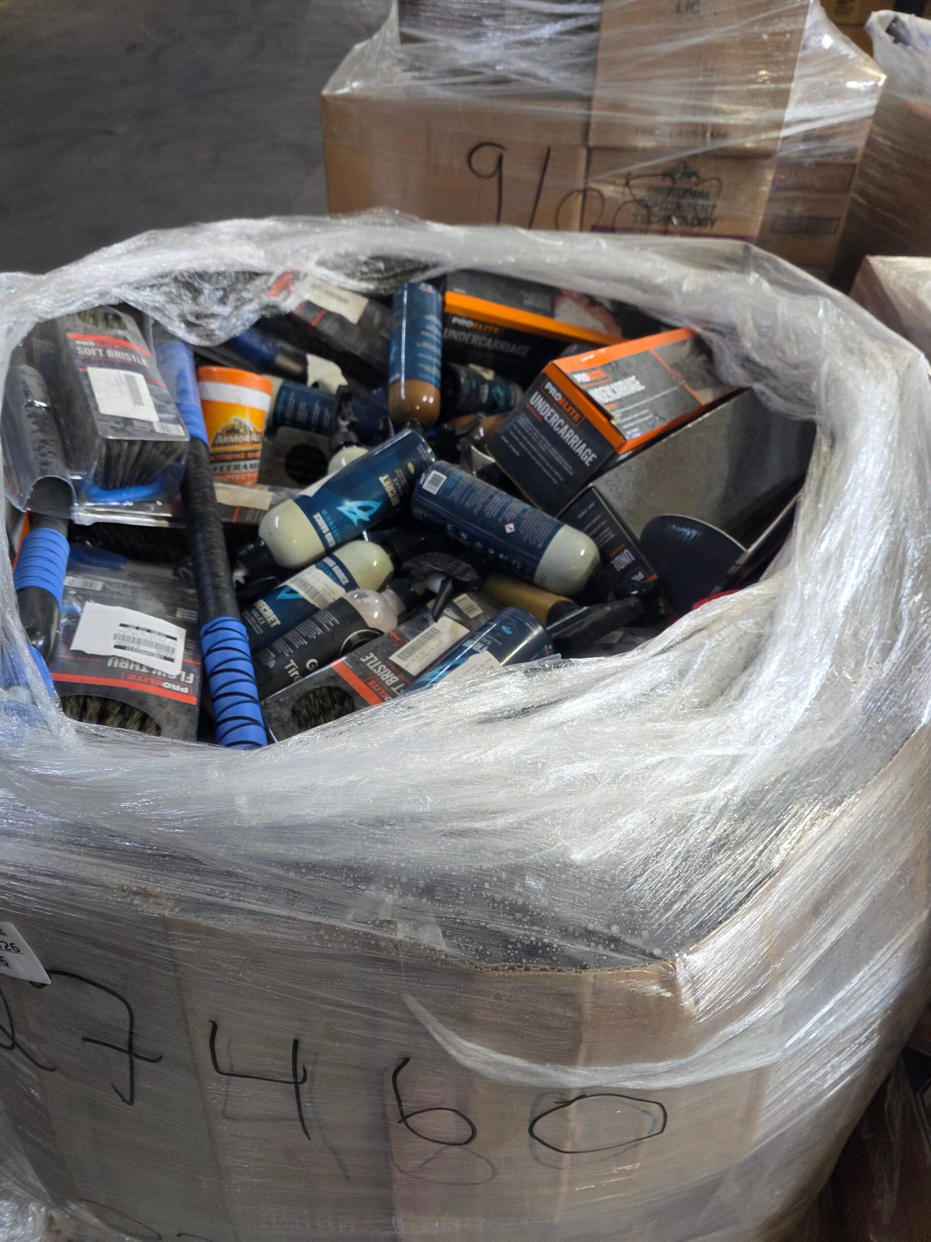 1779221949223_im4fnl Automotive fluids liquidation pallet stacked with sealed motor oil, coolant and transmission fluid jugs