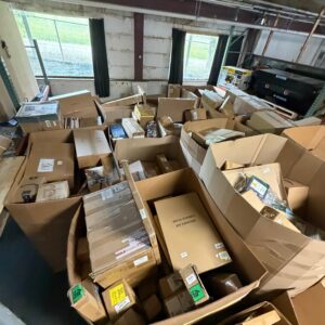Raw Amazon general merchandise pallet stacked 5ft tall with medium boxes of mixed returns