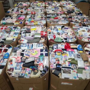 Target accessories liquidation pallet with 1,500+ belts, hats, jewelry and socks stacked for resale