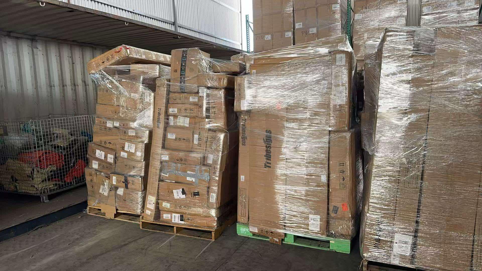 Tribesign-Liquidation-Truckload Tribesigns furniture truckload of desks and bookcases stacked on pallets for resale