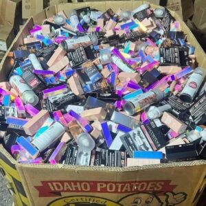 Wholesale makeup pallet stacked with brand-name lipsticks, palettes, and cosmetics for resale
