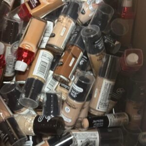 100-unit mixed cosmetic pallet of brand-name makeup and skincare stacked for resale